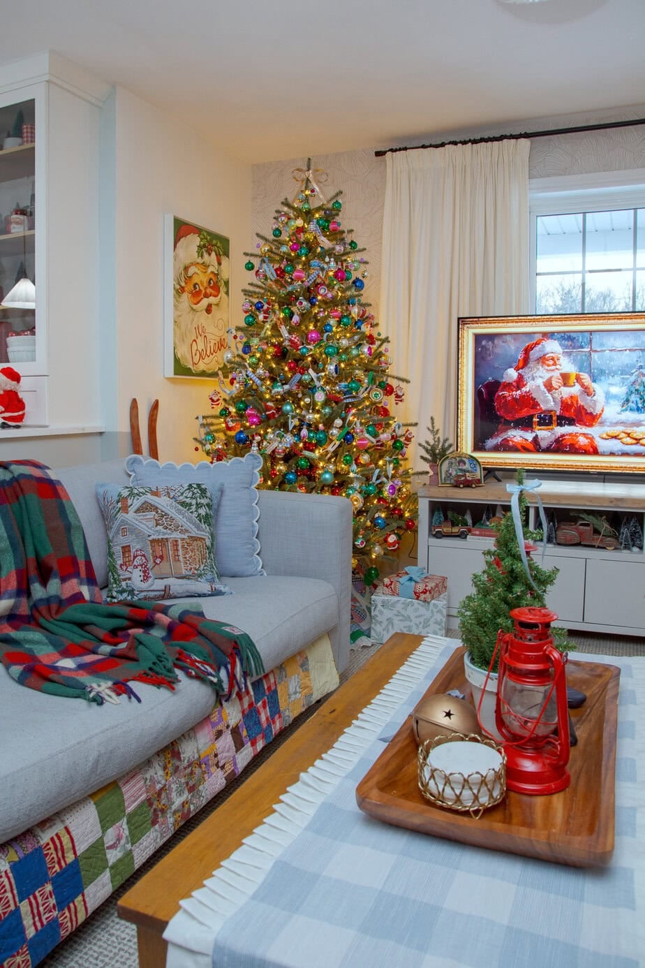 Colorful vintage Christmas tree packed with shiny bright ornaments and warm lights, styled with a patchwork tree skirt.